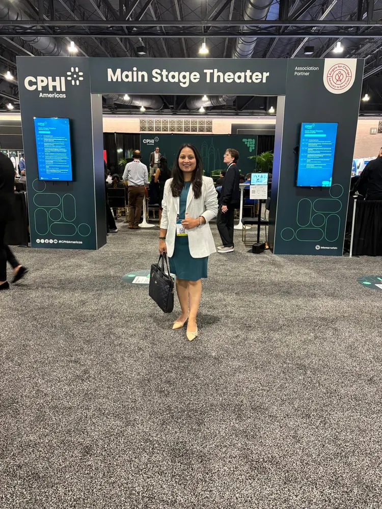 A PharmExpert colleague at the CPHI Main Stage Theater entrance