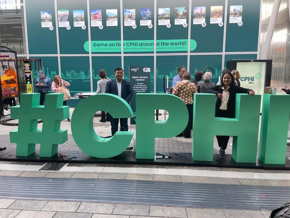 PharmExpert colleagues at the CPHI Worldwide exhibition signage