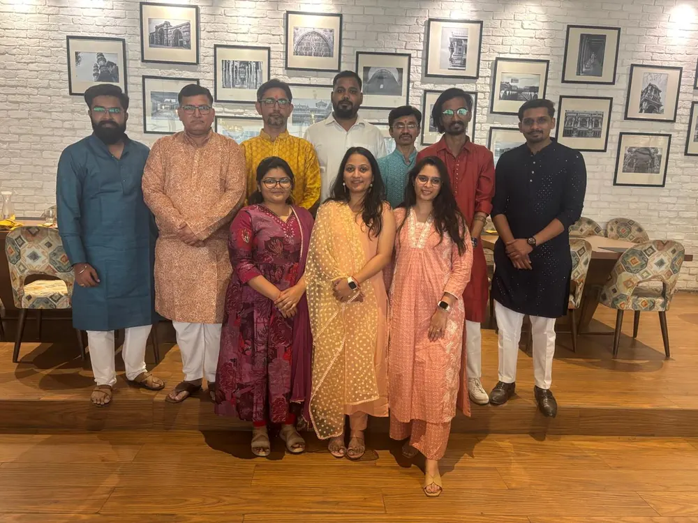 Colleagues in festive traditional dress gathered in the office lounge