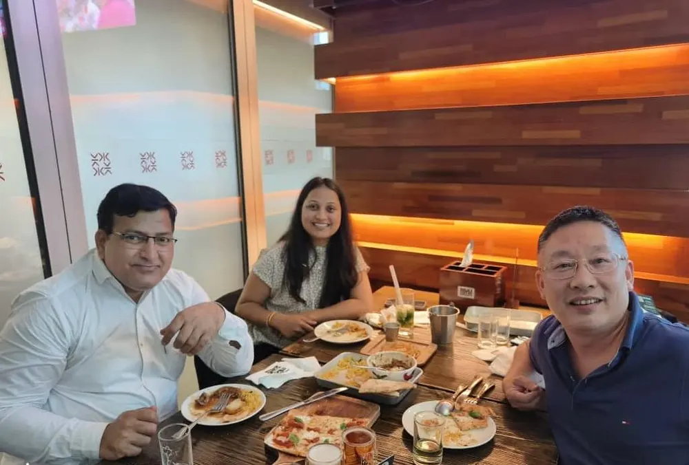 Colleagues sharing a meal with a partner while travelling internationally