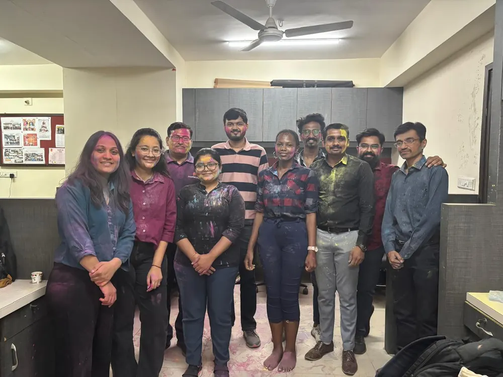 The team photographed together inside the PharmExpert office workspace